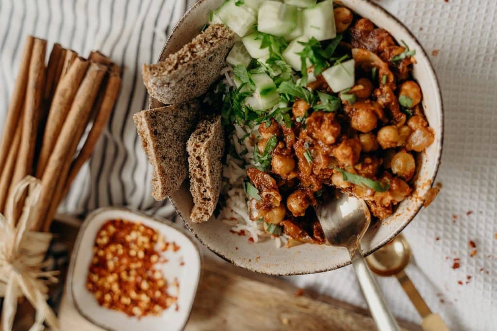 Protein-rich vegan curry bowl with chickpeas, fresh herbs, and whole grains - easy plant-based dinner ideas from our complete guide