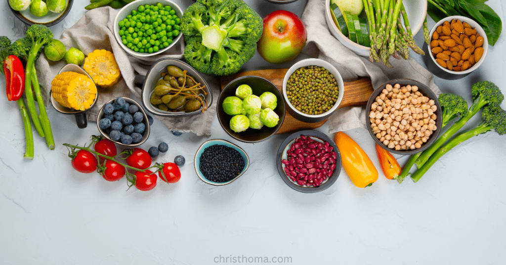 Colorful array of plant-based foods including legumes, fruits, and vegetables for optimal aging nutrition