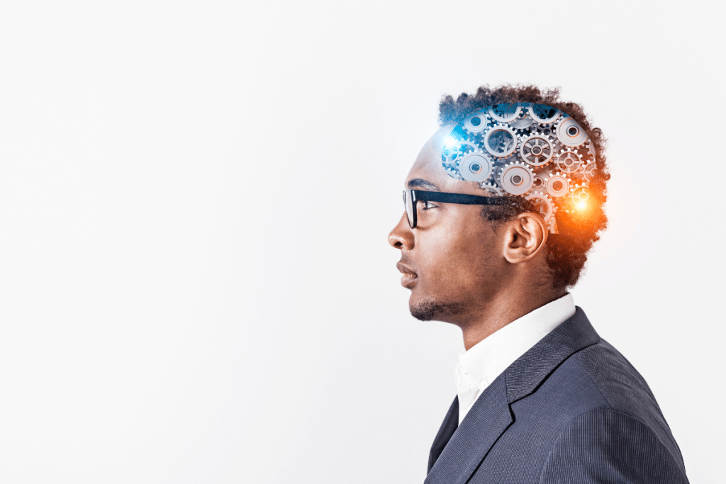 Side profile of business professional with glowing mechanical gears overlaid on head, representing cognitive optimization and brain function